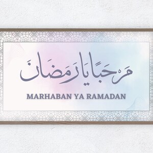 May include: A framed print with a watercolor background and a calligraphy design in Arabic script that reads "Marhaban Ya Ramadan".