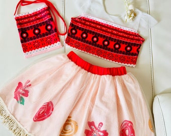 May include: A red and black patterned crop top with a white tulle overlay, a pink tulle skirt with a red waistband and floral designs, and a red and black patterned bag with a strap.