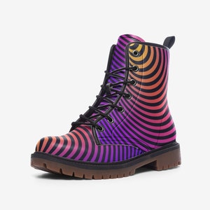 May include: A single combat boot with a vibrant, psychedelic design. The boot has a black sole and laces, with a pattern of concentric, curved stripes in shades of orange, pink, purple, and black. The boot is shown from a side view.