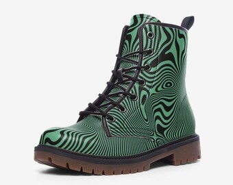 May include: A lace-up ankle boot featuring a vibrant mint green base with a repeating black wavy, hypnotic line pattern. The boot includes black eyelets, black laces, a black collar trim, a pull tab at the heel, and a thick, brown lugged rubber sole.