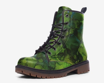May include: Green and blue patterned combat boot with black laces. The boot has a round toe and a brown sole. The upper features a vibrant, abstract design with shades of green and blue, creating a unique and stylish look.