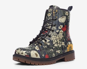 May include: An ankle-high lace-up boot featuring a dark background with a multi-colored floral pattern including white, yellow, and red flowers. The boot has black laces, silver-toned metal eyelets, a pull tab at the heel, and a brown lug sole.