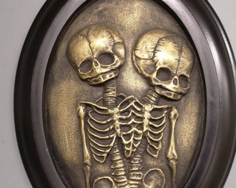 Conjoined twins skeleton framed wall sculpture in Brass