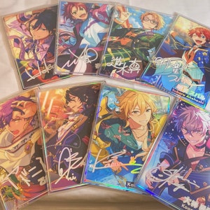 May include: A collection of eight holographic cards featuring anime characters with colorful backgrounds and signatures. The cards are in a variety of poses and expressions. The cards are all different sizes and shapes.