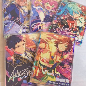 May include: Five colorful cards with holographic borders featuring anime characters. Each card has a signature and a name in Japanese. The characters are:  Hibiki, Madara Mikejima, Yuzuru,  Tsumugi, and  Aoi.