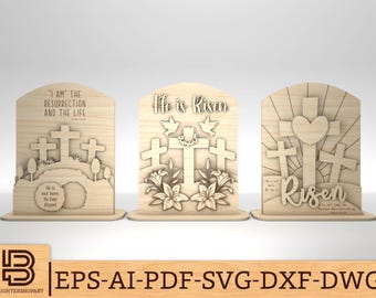 May include: Three wooden signs with Easter themes. The first sign features a cross and the text "I AM THE RESURRECTION AND THE LIFE". The second sign features a cross and the text "He is Risen". The third sign features three crosses and the text "Risen".