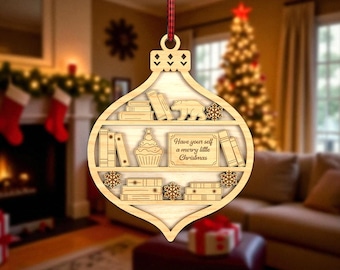 May include: Wooden Christmas ornament shaped like a bookshelf, with books, a cupcake, a bear, and snowflakes. The ornament reads "Have yourself a merry little Christmas". A red and black plaid ribbon is attached for hanging.