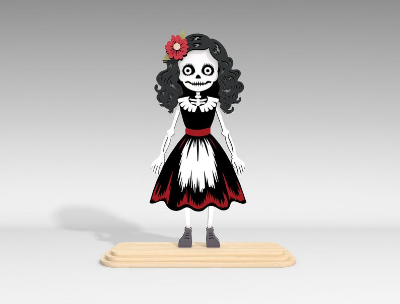 Pu&ograve; includere: Una figura stilizzata di scheletro in un vestito nero e bianco con rifiniture rosse e un fiore rosso tra i capelli. La figura ha capelli neri ricci, un volto scheletrico e si trova su una piattaforma di legno. La figura indossa scarpe grigie.