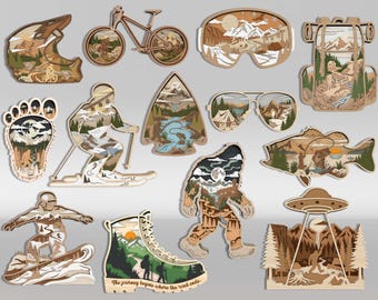 Puede incluir: Una colección de doce recortes de madera en capas con temas al aire libre, que incluyen una bicicleta, gafas de esquí, una mochila, una huella, un esquiador, una punta de flecha, gafas de sol, un pez, un snowboarder, una bota de senderismo, Bigfoot y un OVNI.