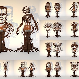 May include: A collection of laser-cut wooden candle holders featuring various horror-themed silhouettes including Frankenstein's monster, skeletons, ghosts, pumpkins, bats, and other spooky figures, each mounted on a tree-shaped base with a tea light.