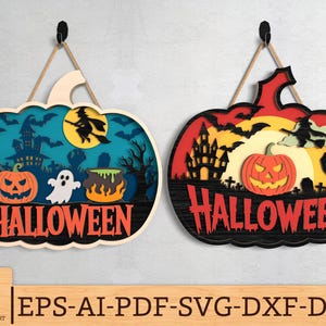 Puede incluir: Dos letreros de madera con temática de Halloween con forma de calabaza. Uno presenta una escena espeluznante con una bruja, una casa embrujada y una linterna de calabaza. El otro letrero tiene un diseño similar con una mano de zombi y la palabra "HALLOWEEN".