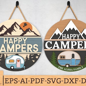 May include: Two wooden signs with a blue and black mountain scene and the text "Happy Campers". Each sign features a camper van with a heart on the side. The sign on the left has the text "The Alissa Family" on the camper van.