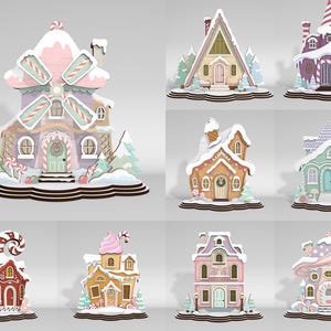 Puede incluir: Una colección de ocho adornos de madera en forma de casas con colores pastel y vibrantes, techos cubiertos de nieve y detalles arquitectónicos temáticos de dulces. Cada estructura se asienta sobre una base escalonada, mostrando varios diseños que incluyen un molino de viento, una cabaña y un edificio en forma de hongo con patrones intrincados.