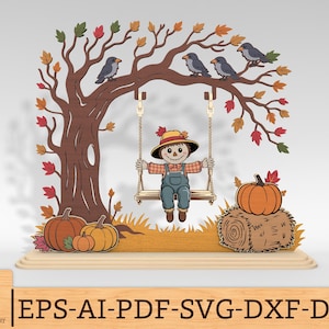 May include: A layered wooden display featuring a scarecrow sitting on a swing suspended from a tree with autumn leaves and birds. The scene includes pumpkins on the ground, a hay bale with a pumpkin, and the text EPS-AI-PDF-SVG-DXF-DWG.