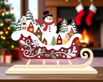 雪だるまそりサインカットSVGファイル、クリスマスビレッジそりSVG、ホリデースノーマンデコレーションSVG、クリスマスオーナメントレーザーカットファイル、Glowforgeファイル