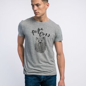 May include: A grey t-shirt with a black bear illustration and the text "papa ours" printed on the front.