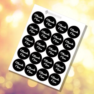 May include: A sheet of black and white round stickers with the text "Thank You" in white lettering on a black background.