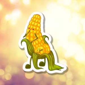 May include: A whimsical sticker featuring a cartoon ear of corn with arms, legs, and a face. The corn is yellow with green husks and the word "Juice" is written on the side. The sticker has a white border.