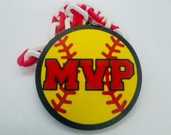 May include: A yellow and red softball with black stitching and the word "MVP" in red letters. The softball is attached to a red and white chain.