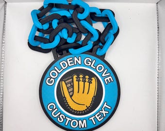 May include: A black and blue chain necklace with a circular pendant. The pendant has a light blue border with the words "GOLDEN GLOVE CUSTOM TEXT" around a baseball glove graphic.