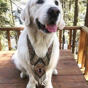 May include: A white Golden Retriever dog wearing a beaded necklace with a smaller golden retriever dog image in the center. The dog is sitting on a wooden deck with a forest background.