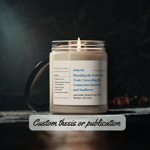 May include: A lit soy aroma candle in a clear glass jar with a black lid. The candle has a white label with text about a journal article titled "Decoding the Preference Trait". The text "Custom thesis or publication" is at the bottom.