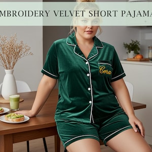 May include: Green velvet short pajama set with white piping. The top has short sleeves, a button-down front, and a breast pocket with embroidered text. The shorts have a matching trim. The text "EMBROIDERY VELVET SHORT PAJAMA" is at the top of the image.