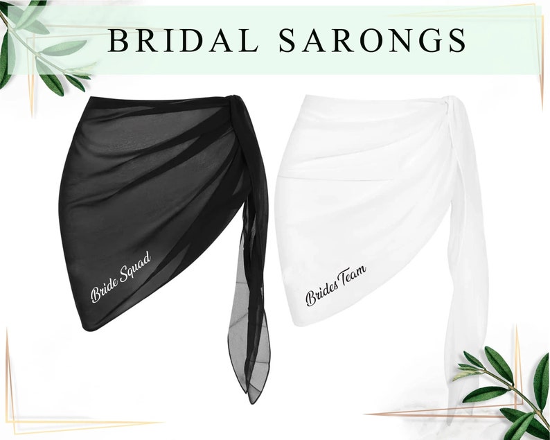 May include: Two sheer sarongs, one black and one white, with the text "Bride Squad" and "Brides Team" embroidered on them.