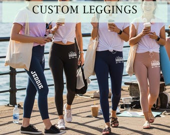May include: Four people wearing custom leggings. The leggings are navy blue, black, and tan. The navy leggings have the name "JEDDIE" printed on the side in white. The black and tan leggings have the words "Nurse Squad" printed on them in white.
