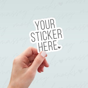 May include: A white sticker with black text that reads "YOUR STICKER HERE" with a small heart symbol. The sticker is being held by a hand.