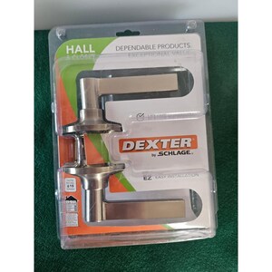May include: Two satin nickel door handles in a plastic packaging. The packaging has the text "Hall Closet", "Dependable Products", "Exceptional Value", "Dexter by Schlage", "EZ Easy Installation", and "Lifetime Guarantee".