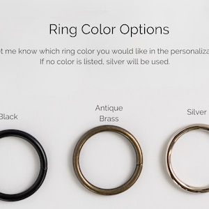 May include: Image showing ring color options: black, antique brass, and silver. Text above reads "Ring Color Options" and provides instructions for personalization. The image displays three circular rings in different metallic finishes.