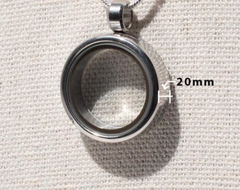 May include: Silver locket necklace with a clear glass insert. The locket is 20mm in diameter.