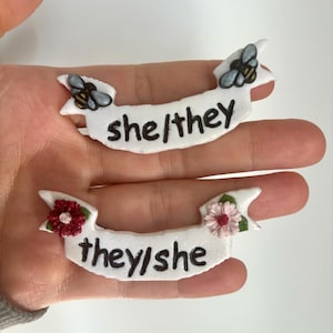 She/They Pronoun Pins // handmade polymer clay pronouns nonbinary gender nonconformity fluid queer lgbtq fem pin for bag jacket nametag