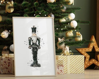 May include: A framed print of a watercolour-style illustration of a nutcracker soldier. The nutcracker is black and green and is standing on a white background.
