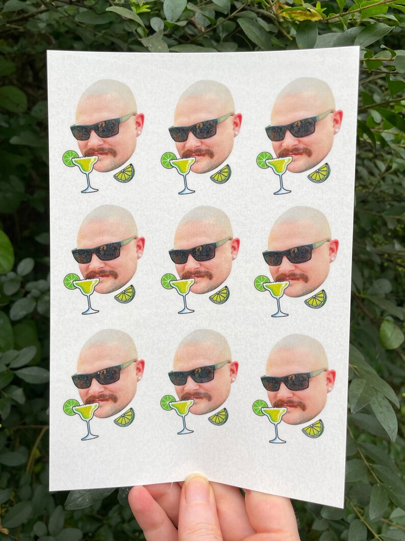 May include: Nine white stickers with a cartoon image of a man wearing sunglasses and a mustache. Each sticker has a margarita glass with a lime wedge and a lime slice.