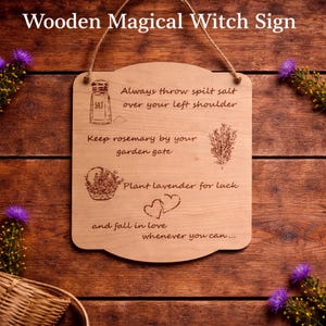 May include: A light brown wooden sign with the text "Wooden Magical Witch Sign". The sign has a curved bottom and is decorated with illustrations and text about witchcraft. It is suspended by a natural fibre rope.