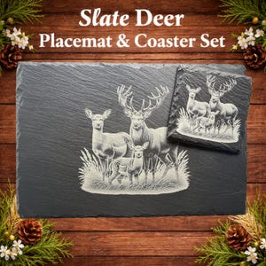 May include: Slate Deer Placemat & Coaster Set. A rectangular slate placemat and square coaster feature an engraved deer family scene. The placemat measures approximately 30 cm by 20 cm. The coaster is about 10 cm square. The text "Slate Deer Placemat & Coaster Set" is at the top.