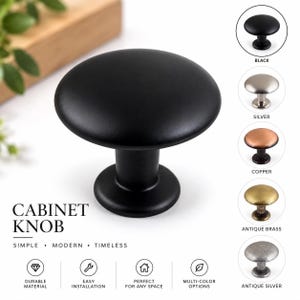 May include: A matte black cabinet knob with a round, flat top and a cylindrical base. The text CABINET KNOB is displayed alongside icons for durable material, easy installation, and multi-color options. Five additional color variations are shown.