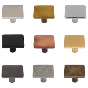 Può includere: Assortimento di pomelli quadrati per armadi in varie finiture, tra cui nichel lucido, ottone, nero, rame, oro, peltro e ottone anticato.