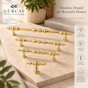 May include: A set of four gold-colored cabinet hardware pieces, including three elongated handles with a decorative ribbed design and one matching T-shaped knob. Each piece features a polished metallic finish and two mounting points.