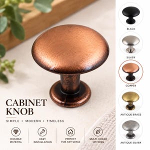 Könnte beinhalten: Ein runder Schrankknopf mit texturierter Kupferoberfläche. Das Bild zeigt den Text CABINET KNOB, SIMPLE, MODERN, TIMELESS, DURABLE MATERIAL, EASY INSTALLATION, PERFECT FOR ANY SPACE, MULTI-COLOR OPTIONS sowie fünf Farbvarianten: Schwarz, Silber, Kupfer, Antikmessing und Antiksilber.