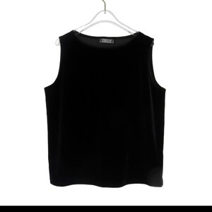 May include: A black sleeveless top made of velvet. The top has a round neckline and a relaxed fit.