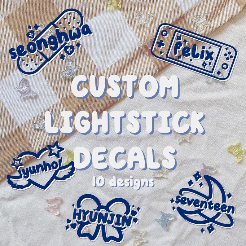 May include: Custom lightstick decals with 10 designs featuring names such as "Seonghwa", "Felix", "Yunho", "Hyunjin", and "Seventeen". The decals are blue and white and are on a checkered background.