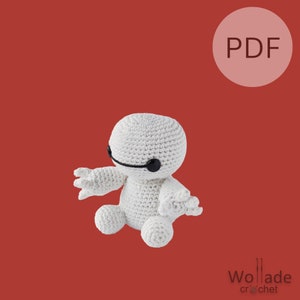 May include: White crocheted amigurumi toy resembling a robot with black eyes. The toy is sitting on a red background with a white circle containing the word "PDF".