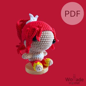May include: Crochet amigurumi pattern PDF for a red-haired girl with a white crown. The pattern includes instructions for making the doll's hair, face, and clothing.
