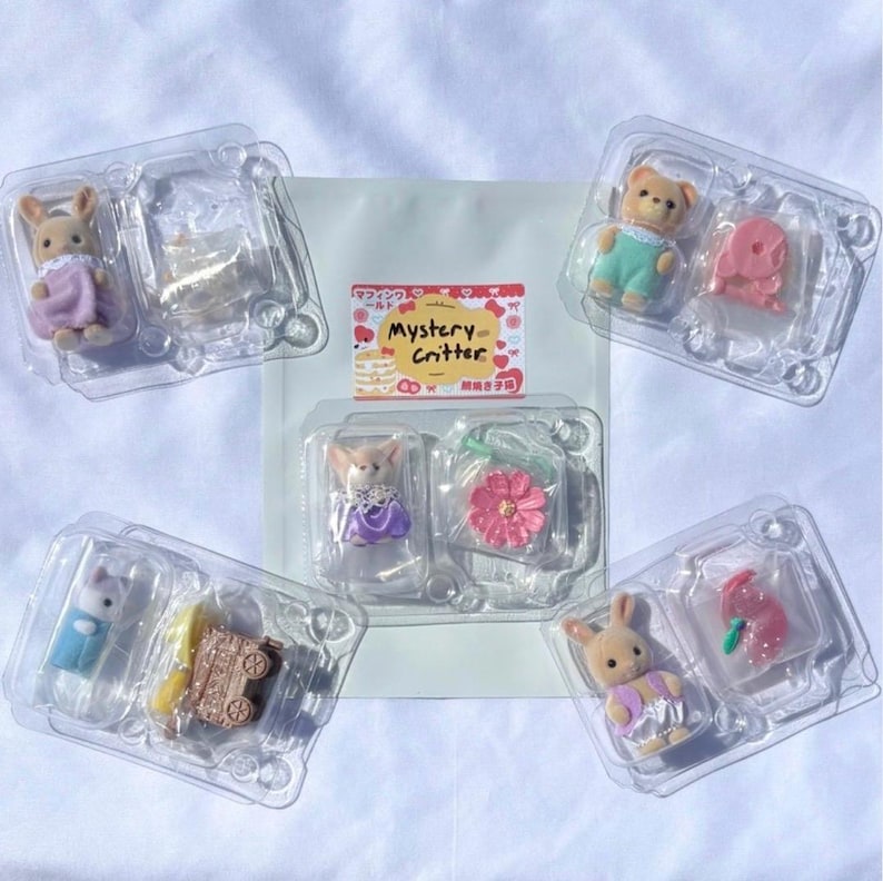 May include: Five clear plastic blister packs containing small flocked animal figurines and miniature accessories. The central pack features the text Mystery Critter with a graphic of a cake. The figures include rabbits and a bear wearing colorful clothing.