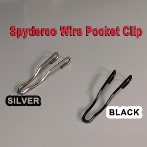 May include: Two Spyderco wire pocket clips, one silver and one black. The clips are designed to attach to a pocket or belt.