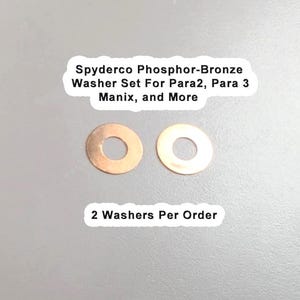 Può includere: Due rondelle Spyderco in bronzo fosforoso color bronzo, con un foro centrale. Il testo sull'immagine recita "Spyderco Phosphor-Bronze Washer Set For Para2, Para 3 Manix, and More" e "2 Washers Per Order".