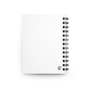 May include: A white spiral bound notebook with a black binding and a small barcode on the bottom right corner.